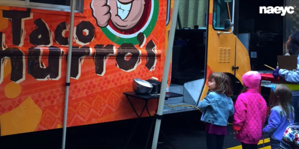 Preschoolers standing at taco truck