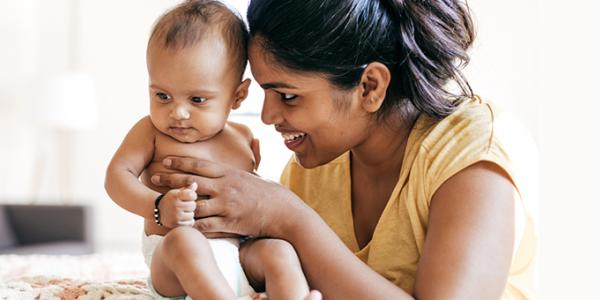 Mother holding infant daughter