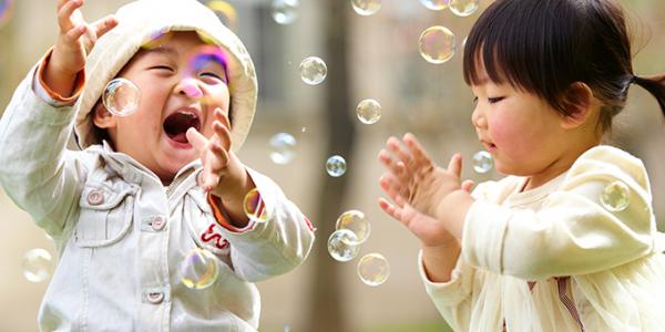 Two toddlers playing and laughing together