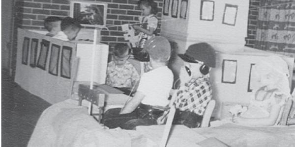 an old photo of children playing in a craft airplane