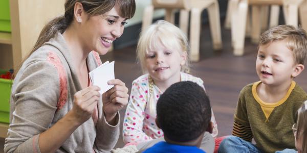 A teacher showing children a picture