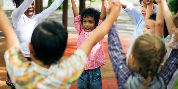 Group of diverse young children playing in a circle