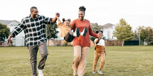 A happy family playing outside.