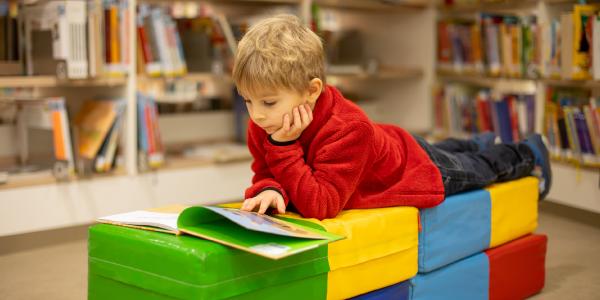 a child reading a book in a classroom