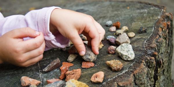 Child playing with rocks