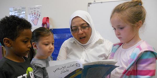 Teacher reading a book to sutdents