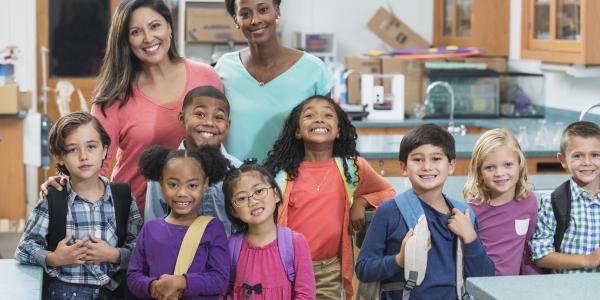 Two teachers and a group of early primary students