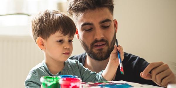 a parent painting with a child