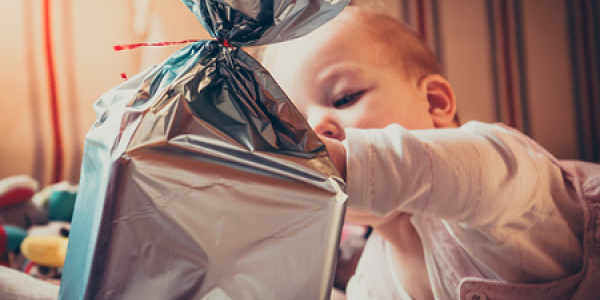 Baby playing with a wrapped gift