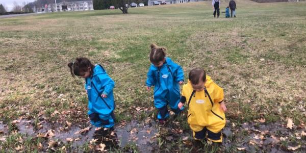 children wading in muddy field