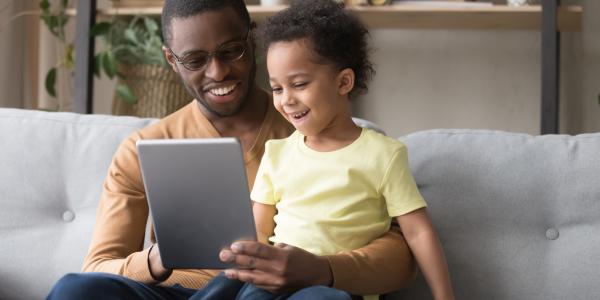 a parent with a child on  a tablet