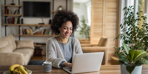 woman on a laptop smiling