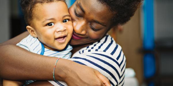 a parent hugging a toddler