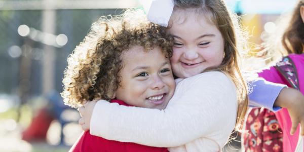 Two preschool children hugging