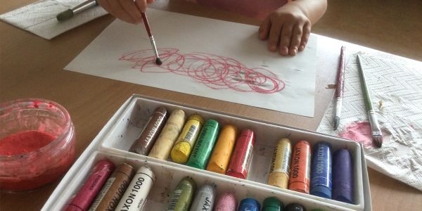 a child using art supplies and paint