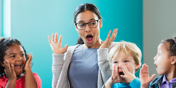 A teacher chants with children.