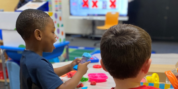Two children working on a project in their classroom