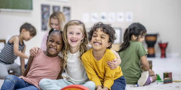 Children posing for a picture in a classroom