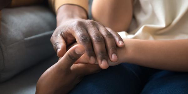 Several people hold hands