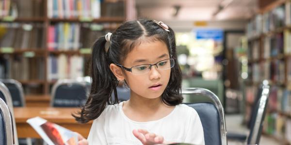 A young child reading a book.