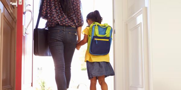 Mother and child holding hands as they walk out door