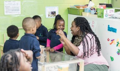 Teacher smiling with her preschool class