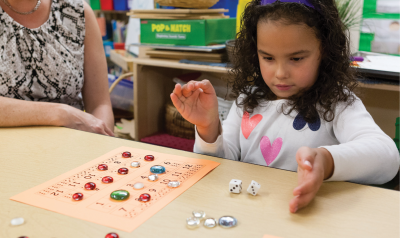 Girl playing with mathematical board game