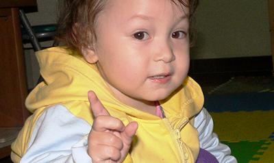 Toddler signaling with a pointer finger to wait