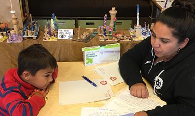 Nadia Jaboneta working with a boy at a desk