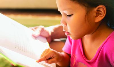 Young child learning to read