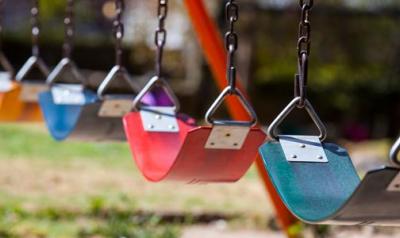 A row of colorful swings on a playground