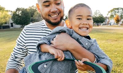 Father and son outside playing