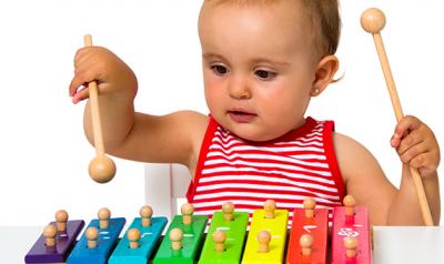 Toddler playing with a music toy.
