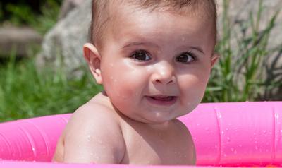 toddler in an outdoor kiddie pool