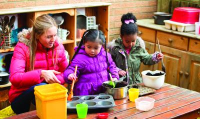 Children playing with kitchen utensils outdoors