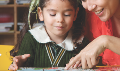 Teacher and child reading a book