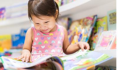 young child reading a picture book