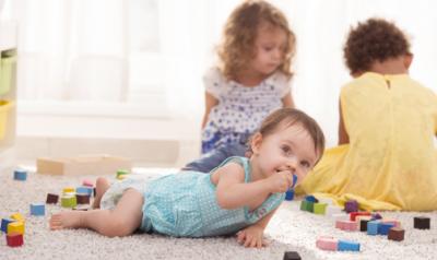 Group of toddlers playing with blocks on the floor