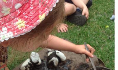 children playing with mud outside