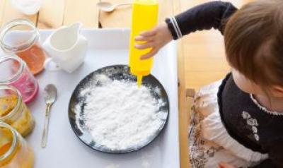 Young child experimenting with various materials