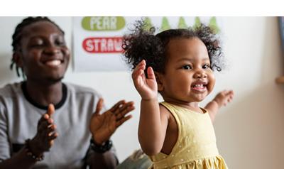 a parent clapping with a happy child