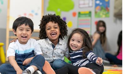 A group of three happy children.