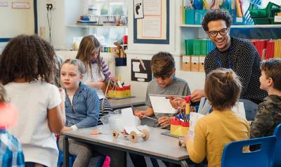 A teacher with students at a classroom table