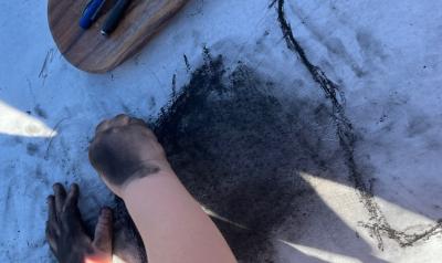 a child drawing with charcoal 