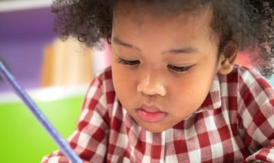 a close up of a child writing