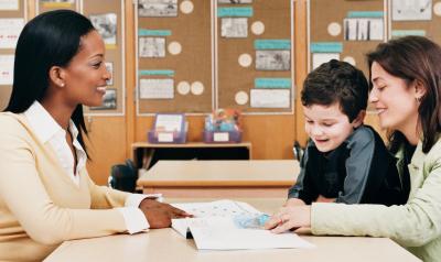 a teacher speaking with a parent and child