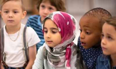 a group of young children focusing on a discussion