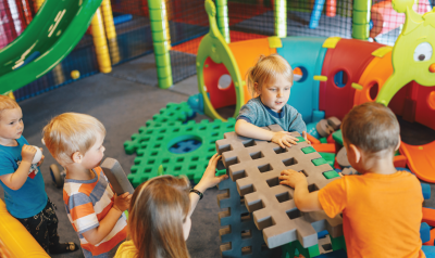 Children work together to build with toys.