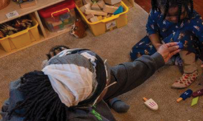 An adult playing with a child
