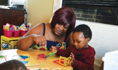 Teacher helping student build structure